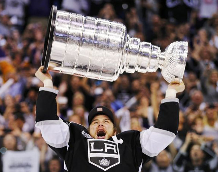 Los Angeles Kings captian Dustin Brown hoists the Stanley Cup 
