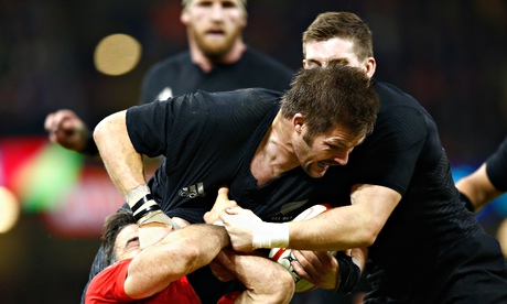 Richie McCaw of the All Blacks is tackled during the Test against Wales at the Millennium Stadium