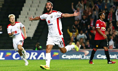 White riot … Will Grigg of MK Dons celebrates scoring against Manchester United in the Capital One C
