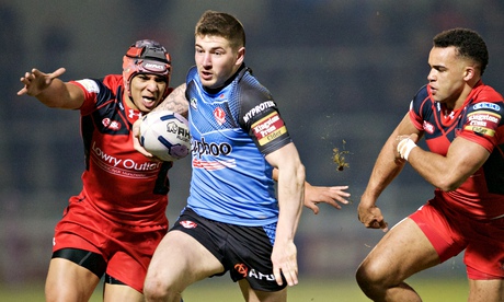 Mark Percival of St Helens breaks tackles on his way to scoring a try against Salford