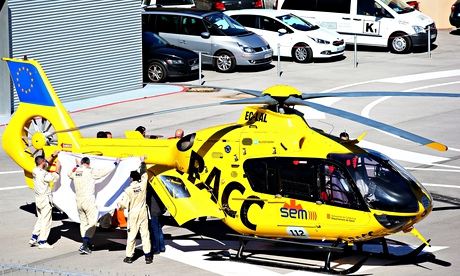 Fernando Alonso is transferred from the medical centre to a helicopter after crashing in F1 testing