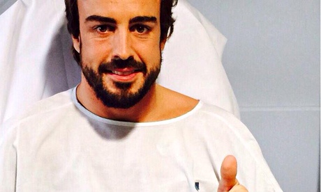 McLaren's Fernando Alonso gives a thumbs-up sign from his hospital bed following Sunday's crash