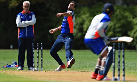Steven Finn bowls as the England coach, Peter Moores, looks on during a nets session in New Zealand