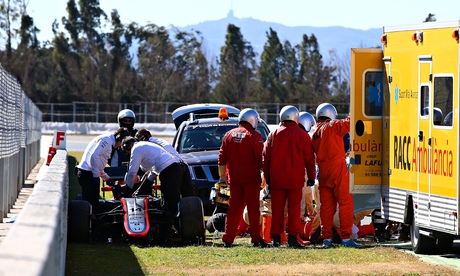 McLaren's Fernando Alonso receives medical assistance after crashing during day four of testing at C