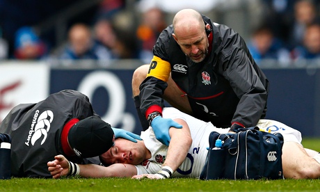 Mike Brown receives medical attention during the Six Nations match between England and Italy on 14 F