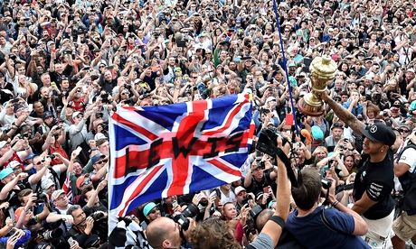 Lewis Hamilton celebrates with the fans after winning the British Grand Prix at Silverstone