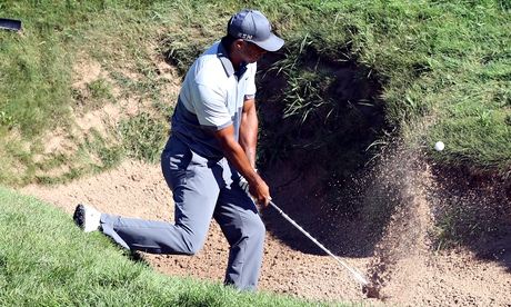 Tiger Woods hits out of a bunker on the ninth hole in a practice round for the US PGA Championship