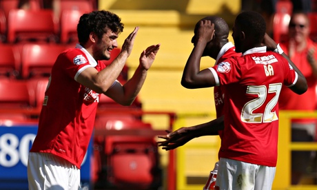 Tony Watt, left, celebrates scoring the opening goal against QPR in the Championship at The Valley
