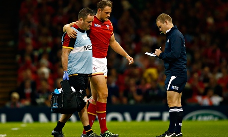 Wales' Cory Allen is helped from the field during the World Cup match against Uruguay