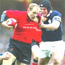 Gareth Thomas tries to escape the clutches of Tom Philip
