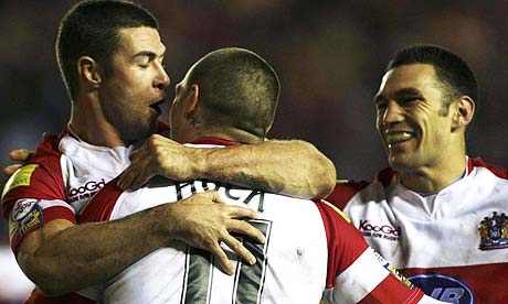 Gareth Hock of the Wigan Warriors celebrates scoring a try with his team-mates 