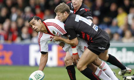 Munster's Lifeimi Mafi, left, evades the tackle of Sale's Richard Wigglesworth