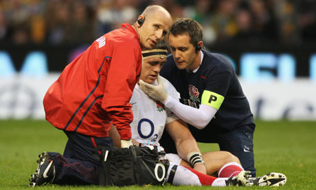 Andrew Sheridan of England is treated after suffering an injury against Australia at Twickenham