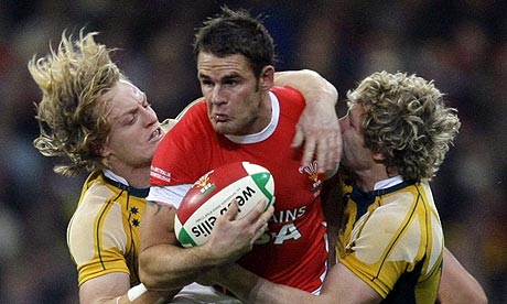 Wales' Lee Byrne is tackled by Australia's Ryan Cross and Peter Hynes