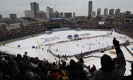 Fans cheer during the first period of the NHL Winter Classic