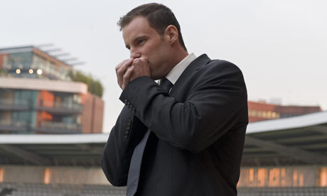 Andrew Strauss blows on his cold hands as he poses for photos on the home balcony at Lords 