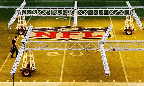 A worker prepares the pitch at Wembley