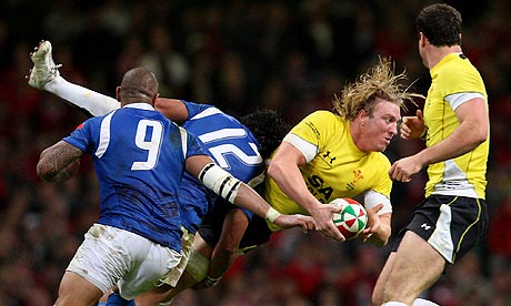 Andy Powell is tackled by Seilala Mapusua during Wales's win over Samoa
