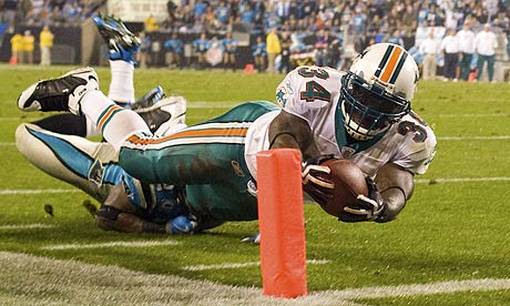 Ricky Williams dives into the end zone during the Miami Dolphins' win over the Carolina Panthers