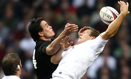 New Zealand's Zac Guildford and England's Jonny Wilkinson jump for a high ball