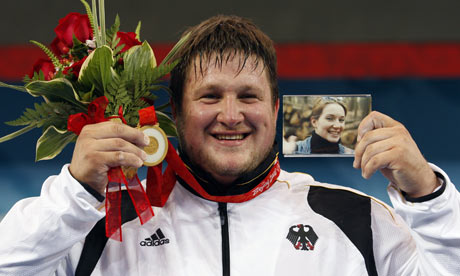 Matthias Steiner holds a photo of his late wife