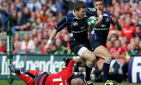 Leinster centre Gordon D'Arcy races past Munster's Keith Earles to score a try during their semi