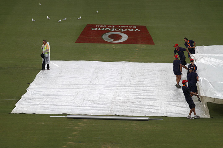 Ashes: Ground keepers cover the pitch in Adelaide