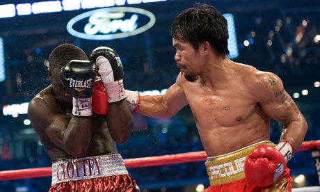 Joshua Clottey defends himself from a righthand blow from Manny Pacquiao 