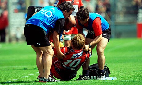 Toulon's Jonny Wilkinson is helped to his feet after injuring his back against Cardiff