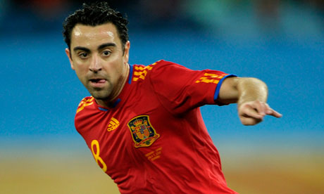 Spain's midfielder Xavi passes the ball