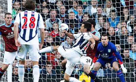 West Bromwich Albion's Paul Scharner, centre, scores against Aston Villa.