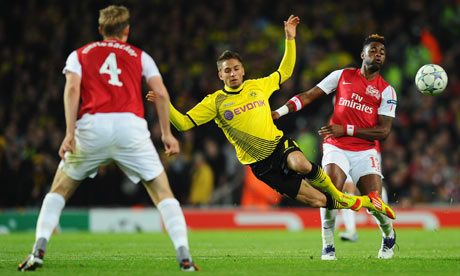 Arsenal's Alex Song stops the progress of Moritz Leitner of Borussia Dortmund