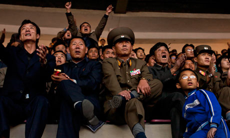 North Korean fans watch the World Cup qualifying match against Uzbekistan at the Yanggakdo Stadium