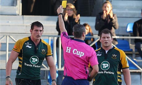 Tom Wood of Northampton, left, is shown the yellow card by referee John Lacey