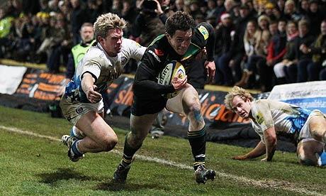 Northampton's Jamie Elliott sprints away from an attempted tackle by Bath's Michael Claassens