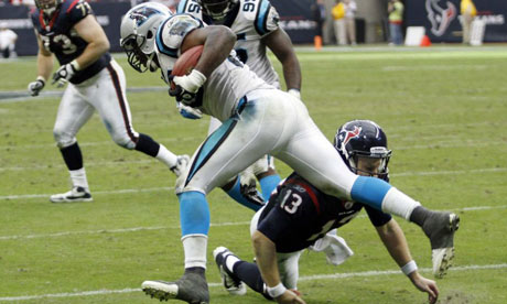 Houston Texans quarterback T.J. Yates trips Carolina Panthers' James Anderson