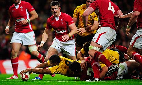 Australia's Will Genia stretches to score his side's first try during the 24-18 win against Wales