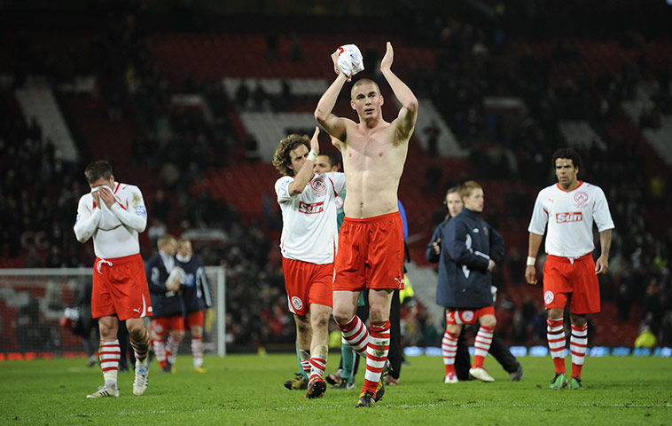 Man Utd v Crawley: Richard Brodie and team-mates applaud their fans after the game