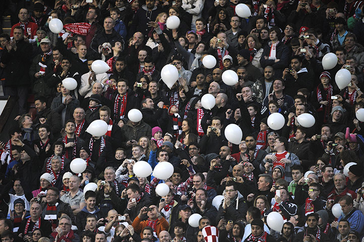 Man Utd v Crawley: The Crawley fans release balloons as the teams come out