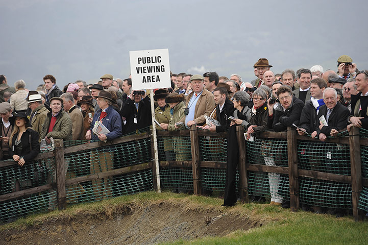 Cheltenham Day 1: The crowd in the middle of the course watch the cross-country race