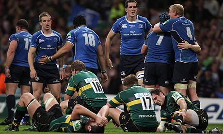 Leinster players celebrate victory in the Heineken Cup final while Northampton players look dejected