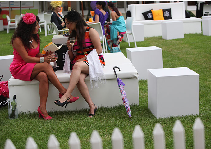 Royal Ascot Day 2: Racegoers enjoy a drink whilst perusing the form guide