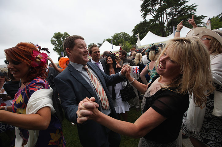 Royal Ascot Day 2: Racegoers sing and dance around the Bandstand at Ascot