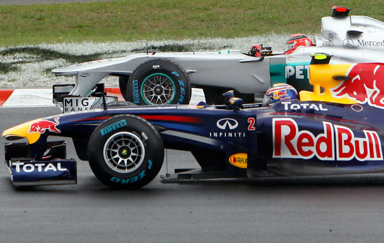 Mark Webber and Michael Schumacher race side-by-sde at the Hungarian Grand Prix