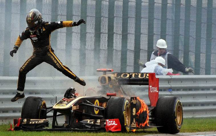 Nick Heidfeld makes a hasty escape as his car catches fire at the Hungary Grand Prix