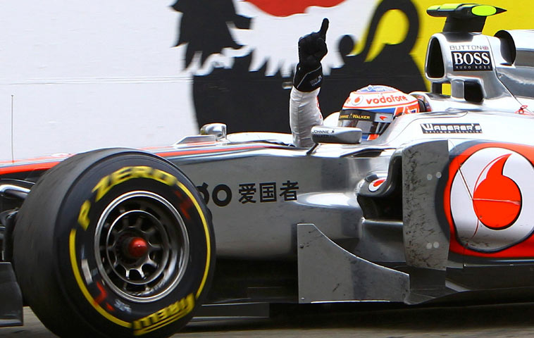 Jenson Button celebrates a sensational drive as he wins in Hungary
