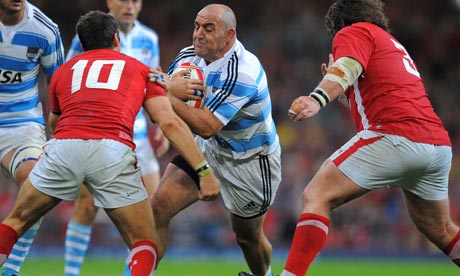 Argentina's Mario Ledsma runs at James Hook, the Wales fly-half, in Cardiff.
