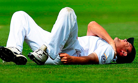 Jonathan Trott lies injured after hurting his shoulder during England's second Test against India 