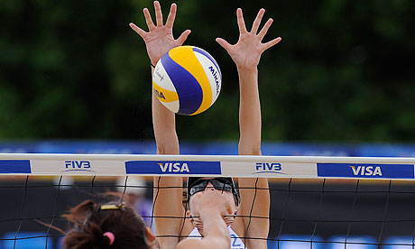 Elizabeth Maloney of Canada makes a block in her match with partner Heather Barnsley