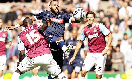Millwall's Liam Trotter takes on Abdoulaye Faye of West Ham United.